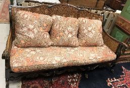 An early 20th Century walnut framed and caned Bergère settee in the Flemish taste,