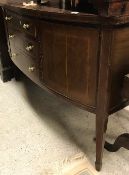 A Sheraton Revival mahogany and inlaid bow fronted sideboard with three drawers flanked by two