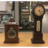 An oak mantel clock with English movement, the brass dial set with Roman numerals,