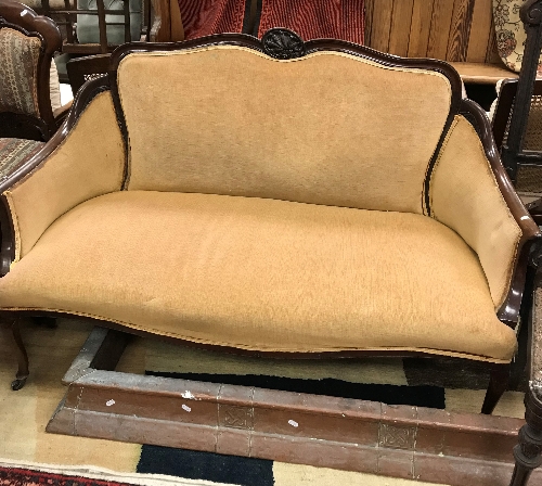 An Edwardian mahogany framed salon settee on cabriole front legs to castors,