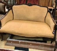 An Edwardian mahogany framed salon settee on cabriole front legs to castors,