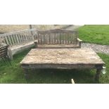 A large wooden garden table with two wooden benches