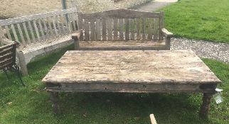 A large wooden garden table with two wooden benches