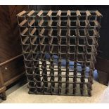 A wooden and metal 80 bottle wine rack