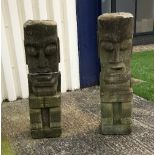 A pair of Easter Island style stone figures