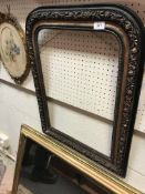 A 19th Century French ebonised arched mirror with floral decoration