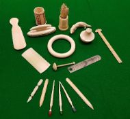 A collection of small 19th and early 20th Century ivory items to include cane handle combs, ruler,