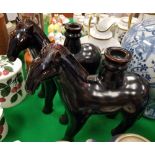 A pair of modern Chinese treacle-glazed pottery figures of horses as candlesticks,