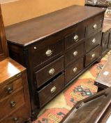 A 19th Century North Country English oak and crossbanded mule chest the top rising over three dummy