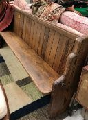 A late Victorian pitch pine chapel pew with end brass stick rail