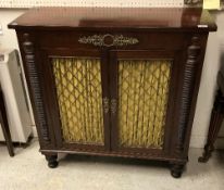 An early 19th Century mahogany and rosewood crossbanded chiffonier the plain top above two lattice