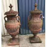 A pair of large lidded terracotta urns with grape and vine decoration CONDITION REPORTS