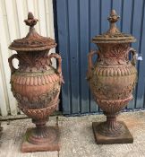 A pair of large lidded terracotta urns with grape and vine decoration CONDITION REPORTS