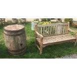 A large wooden barrel with two benches