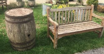 A large wooden barrel with two benches