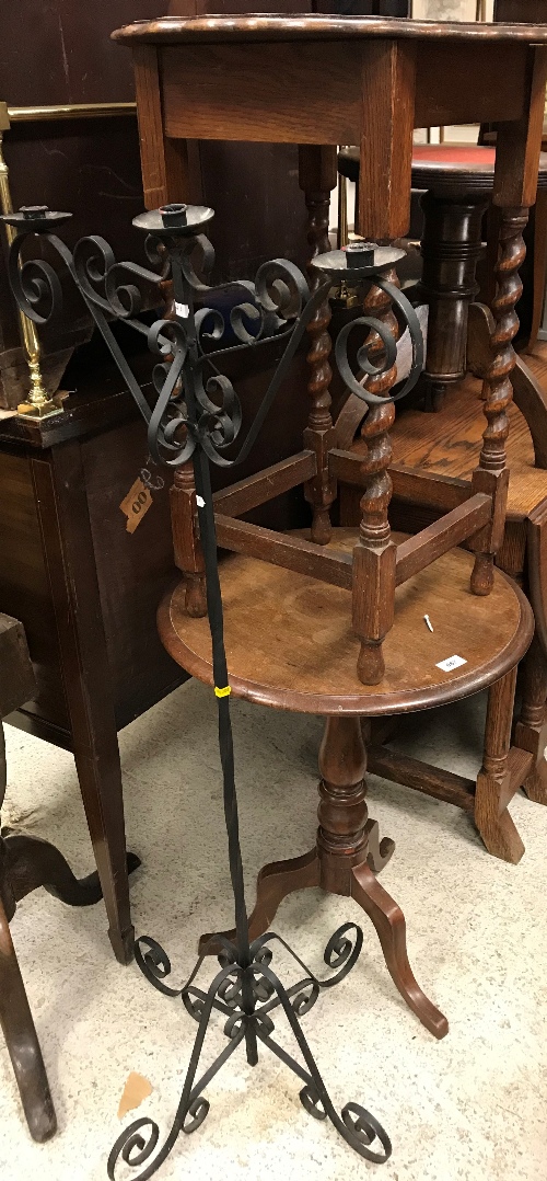 An oak tripod occasional table together with a further oak occasional table and a wrought iron