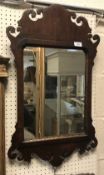 A mahogany framed fretwork carved wall mirror