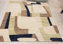 A large modern rug of abstract design in olive brown, blue and cream,
