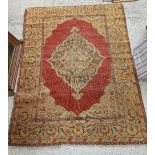 A Ushak rug, the central panel set with floral decorated medallion on a red ground, within a red,