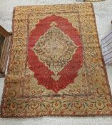 A Ushak rug, the central panel set with floral decorated medallion on a red ground, within a red,