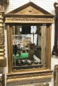 A modern moulded gilt framed wall mirror with bevelled rectangular plate