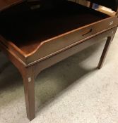 A mahogany butler's tray on a stand with square chamfered legs