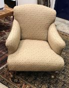 A late Victorian upholstered armchair in the manner of Howard of London the rear leg stamped