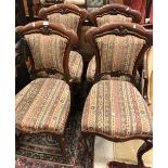 A set of four Victorian mahogany framed dining chairs with upholstered back and seat