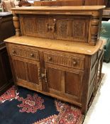 A mid 20th Century carved oak court cupboard,