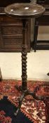 A circa 1900 mahogany torchère stand on barley-twist support to carved cabriole tripod base