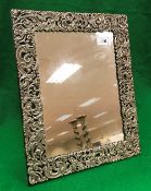 A Victorian silver mirror frame with pierced scrolling decoration (London 1897)