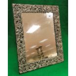 A Victorian silver mirror frame with pierced scrolling decoration (London 1897)