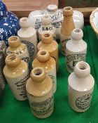 A collection of ten stoneware ginger beer bottles including "Cheltenham Spa Mineral Water Company",