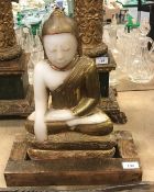 A carved alabaster Buddha in the lotus position with gilt decoration CONDITION REPORTS