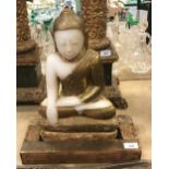 A carved alabaster Buddha in the lotus position with gilt decoration CONDITION REPORTS