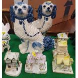A pair of Staffordshire blue and white glazed pottery spaniel figures inscribed to base "Hand