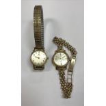 A ladies gold cased Omega Seamaster DeVille wristwatch with 9 carat chainlink strap and a ladies