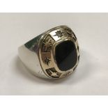 A diamond and onyx set 14 carat gold mounted college ring