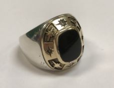 A diamond and onyx set 14 carat gold mounted college ring