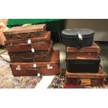 A collection of seven various leather or leather effect suitcases and a Charles of The Ritz hat box