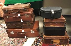 A collection of seven various leather or leather effect suitcases and a Charles of The Ritz hat box