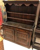 An 18th Century oak dresser (probably Northern European) the two tier boarded plate rack over two