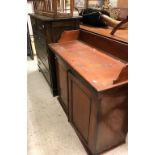 A Victorian mahogany dwarf cabinet with three quartered galleried top over two cupboard doors