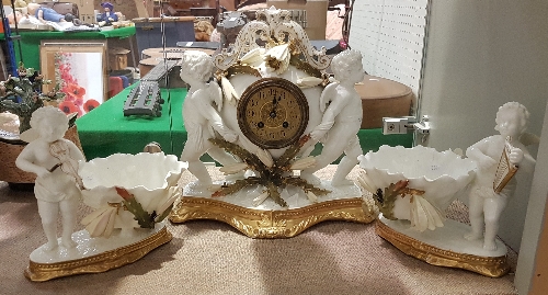 A 19th Century Moore Brothers clock garniture as two cherubs with floral decoration,