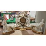 A 19th Century Moore Brothers clock garniture as two cherubs with floral decoration,