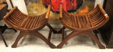 A pair of modern teak slatted X frame stools