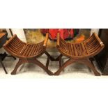 A pair of modern teak slatted X frame stools