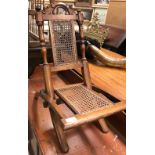 A Victorian child's walnut framed and caned folding chair