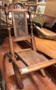 A Victorian child's walnut framed and caned folding chair