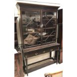 A 19th Century mahogany bookcase cabinet with astragal-glazed doors enclosing adjustable shelving,